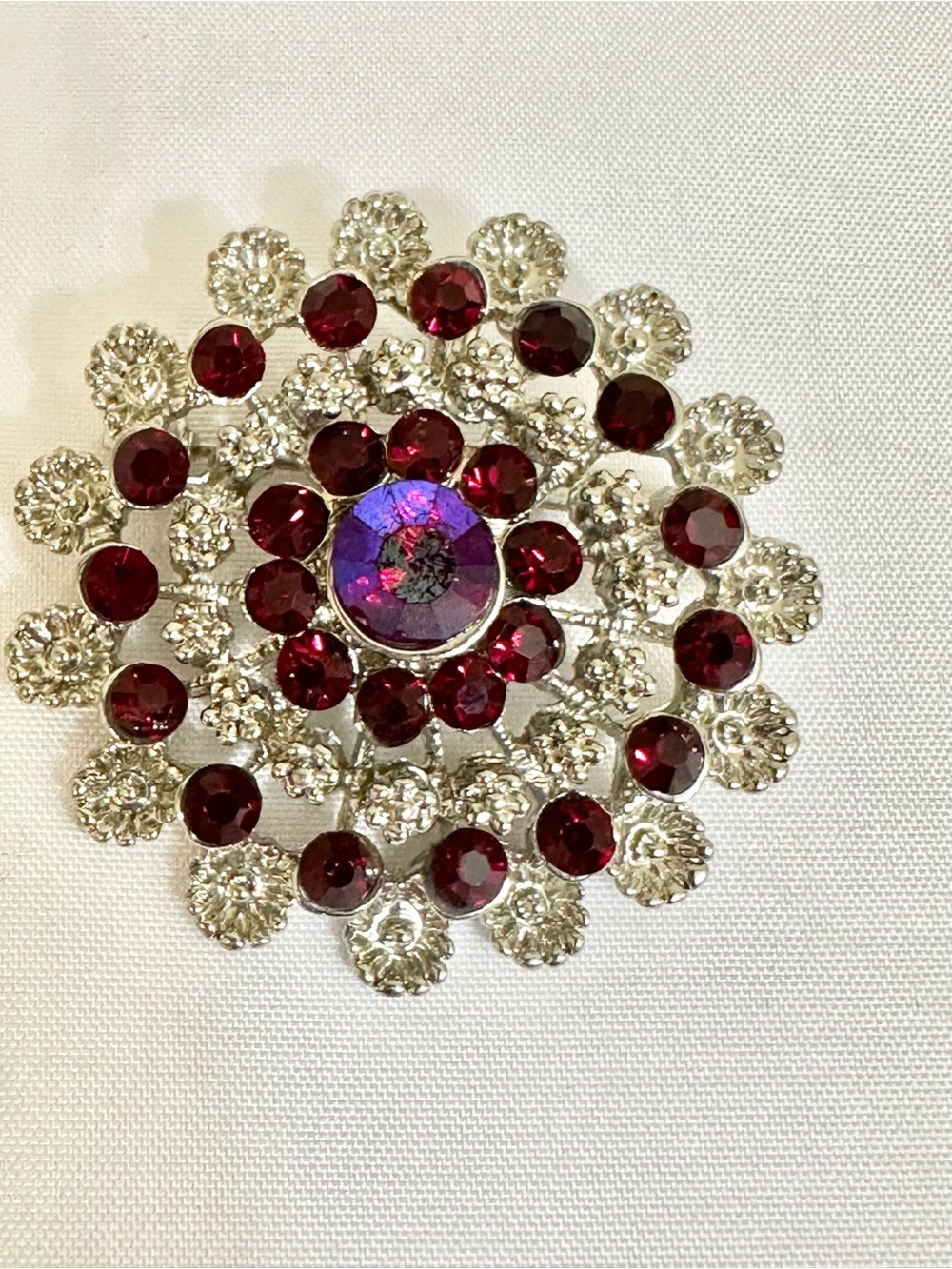 Vintage Silver-Tone Brooch with Deep Red and Iridescent Center